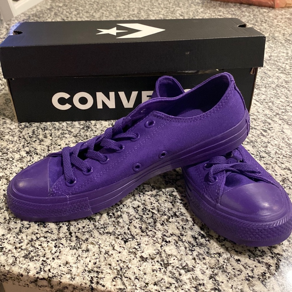 New, unworn, Purple converse shoes.